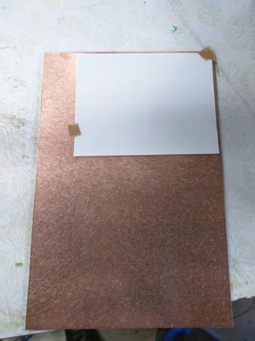 The printed reverse screen is taped to the copper of the board.
