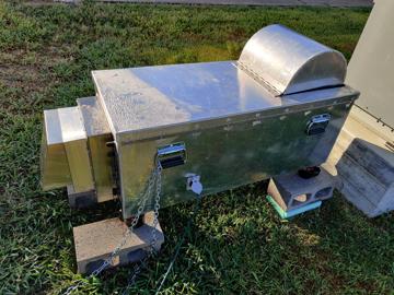 The first iteration of the aluminum enclosure for the EM27/Sun for our project. This is in a closed state with dew covering it in the morning. The enclosure is on cinder blocks to level the instrument and the enclosure is chained to prevent theft.