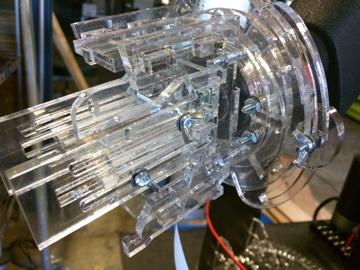 The Raspberry Pi camera is affixed to the scope's eyepiece with a complicated looking adjustable clamp